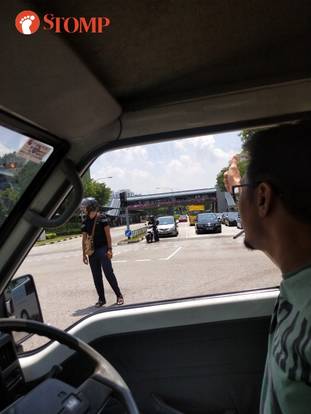 Woodlands traffic light spoiled, biker voluntarily stand under hot sun directing traffic