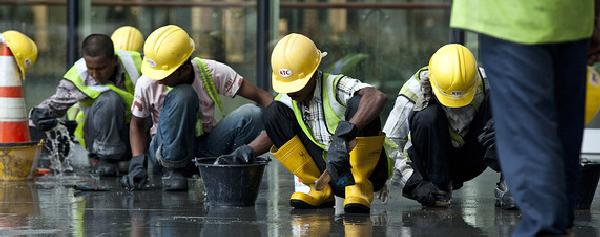 Kid breaks glass bottle, mom walks away, foreign worker cleans up broken glass