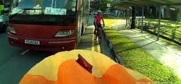 Woman falls off bike as bus drove too close to her